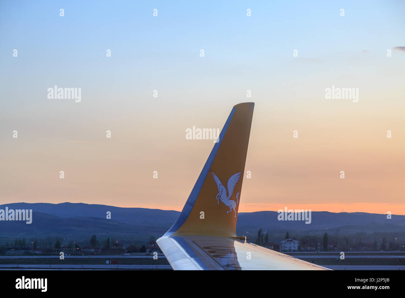 At Esenboga airport in Ankara, Turkey - April 29, 2017 : Pegasus airlines plane inside the Esenboga airport during sunset Stock Photo