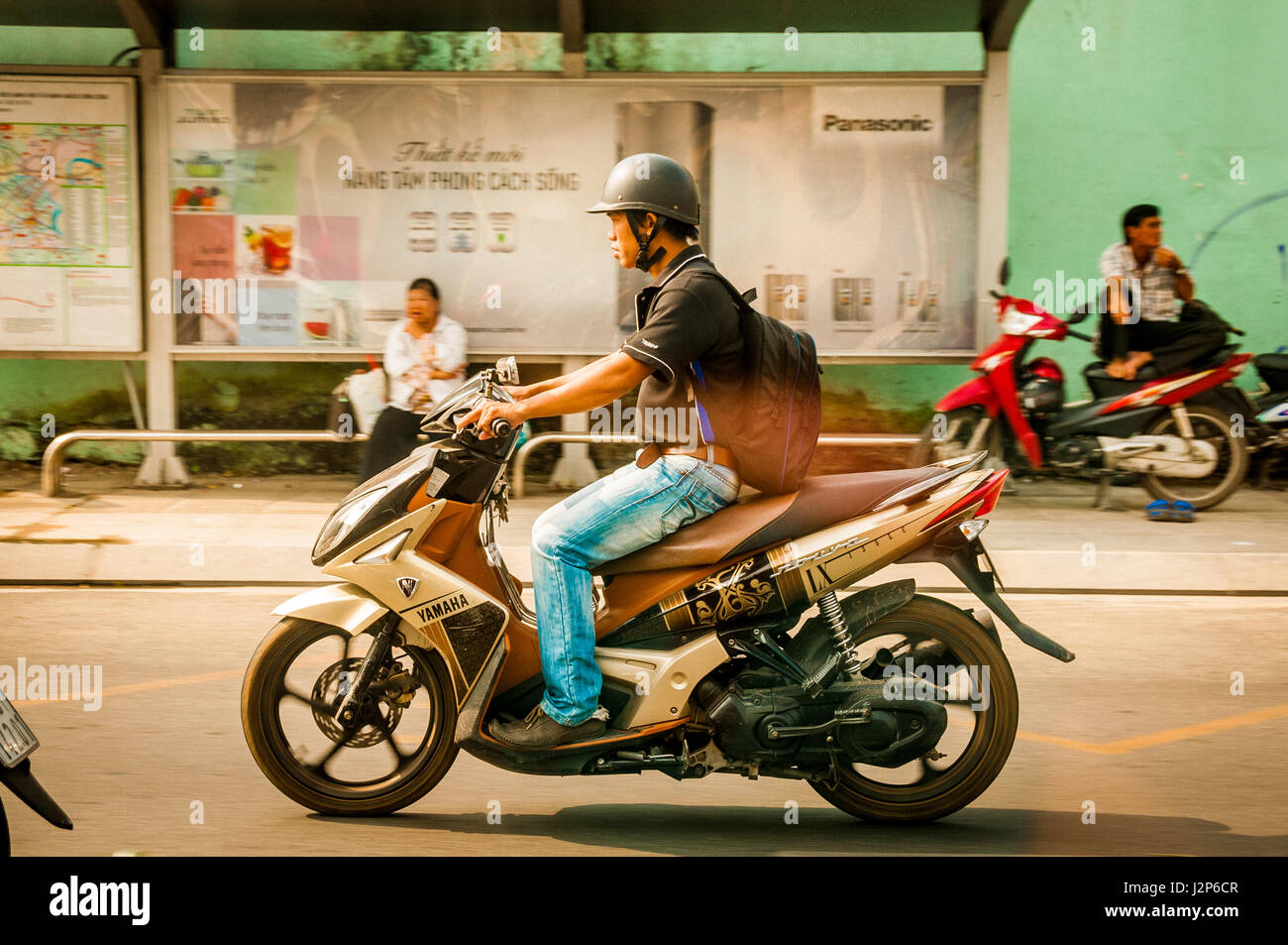 Ho Chi Minh city, VIETNAM - MARCH 29, 2017: men driving a scooter outdoor in Ho Chi Minh city, Vietnam , retro filter Stock Photo