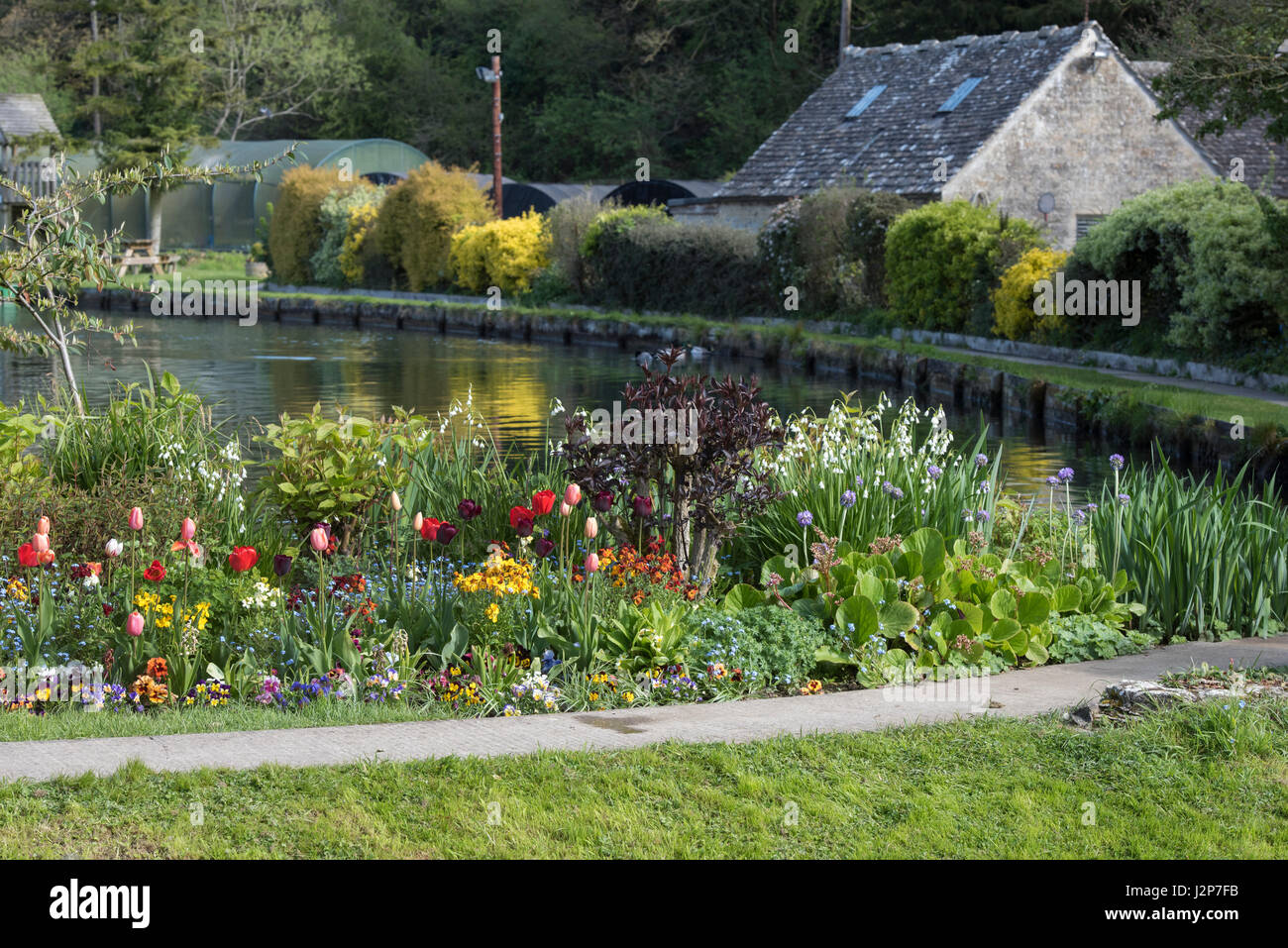 Colourful flowerbed on the edges of Bibury Trout Farm. Bibury
