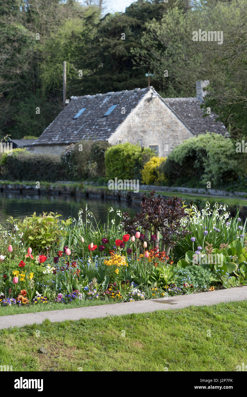 Colourful flowerbed on the edges of Bibury Trout Farm. Bibury