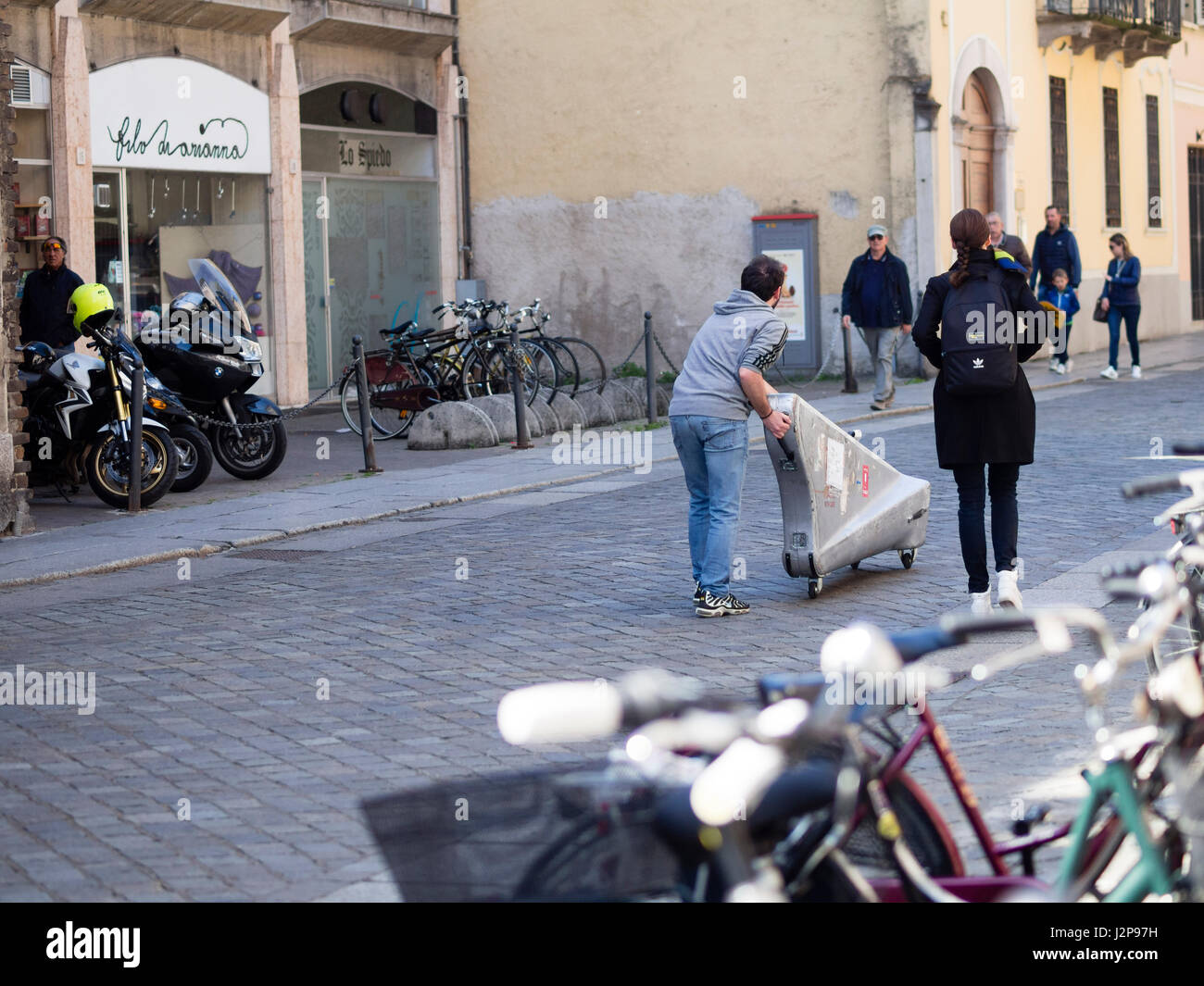 Luthier transporting an packed harp in the streets of  Cremona, Italy Spring 30th April 2017 Stock Photo