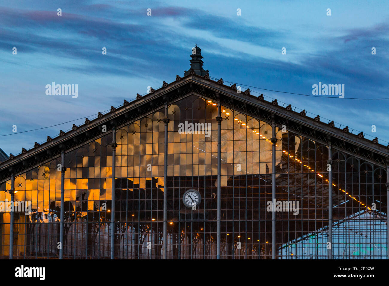 A reflection of sunset on the lattice window of the Nyugati Railway Station in Budapest Stock Photo