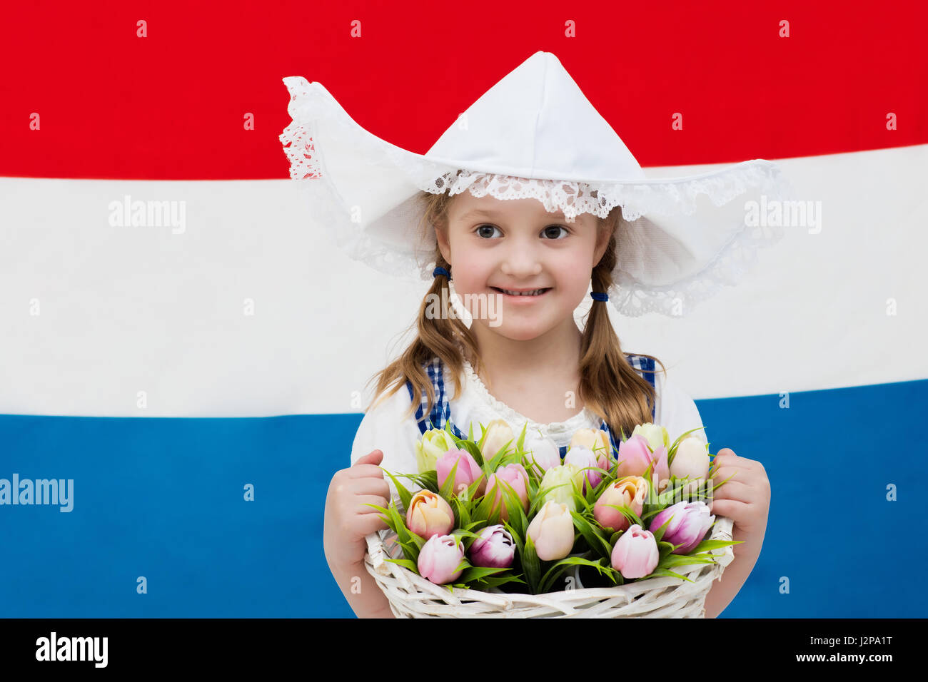 Little Dutch girl wearing traditional national costume, dress and hat ...