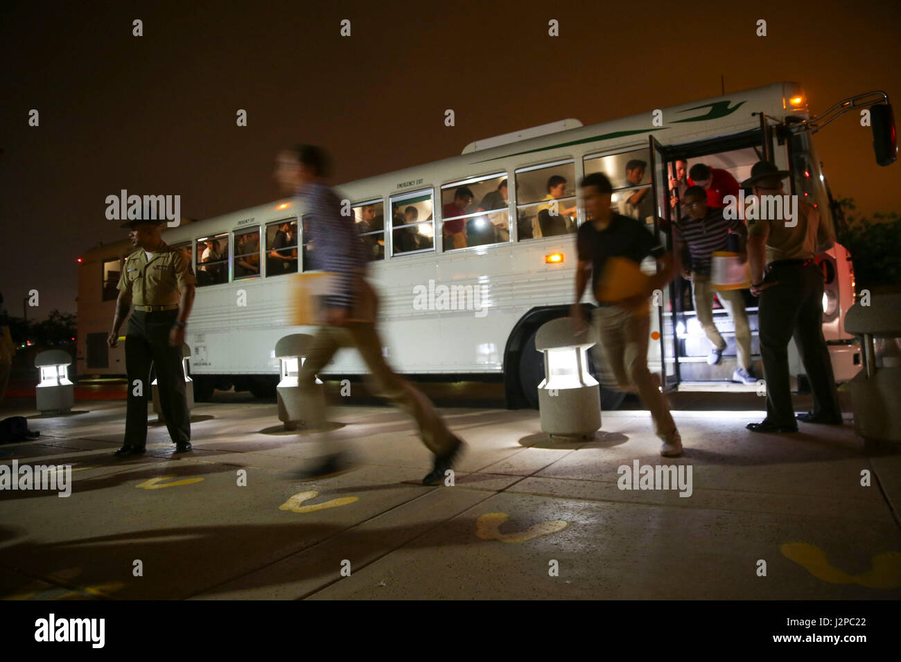 New recruits of Hotel Company, 2nd Recruit Training Battalion, are welcomed to the depot as they exit the bus and step onto the yellow footprints during receiving at Marine Corps Recruit Depot San Diego, April 17. From this point on, recruits will eat, sleep and train as a team as they begin the transformation from civilian to Marine. Annually, more than 17,000 males recruited from the Western Recruiting Region are trained at MCRD San Diego. Hotel Company is scheduled to graduate July 14. Stock Photo