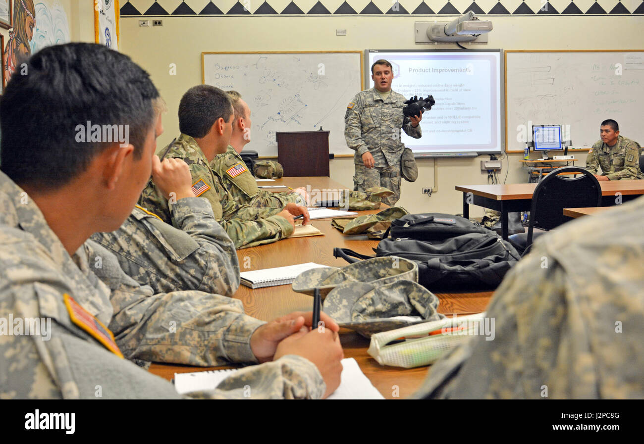 HONOLULU, Hawaii- Chemical, Biological, Radiological and Nuclear Soldier Pvt. Evan Darmody (standing), a subject matter expert with the 71st Chemical Company, 303rd Ordnance Disposal Battalion (EOD), 8th Military Police Brigade, 8th Theater Sustainment Command, shares his CBRN expertise with University of Hawaii Army ROTC cadets April 19, here. Stock Photo