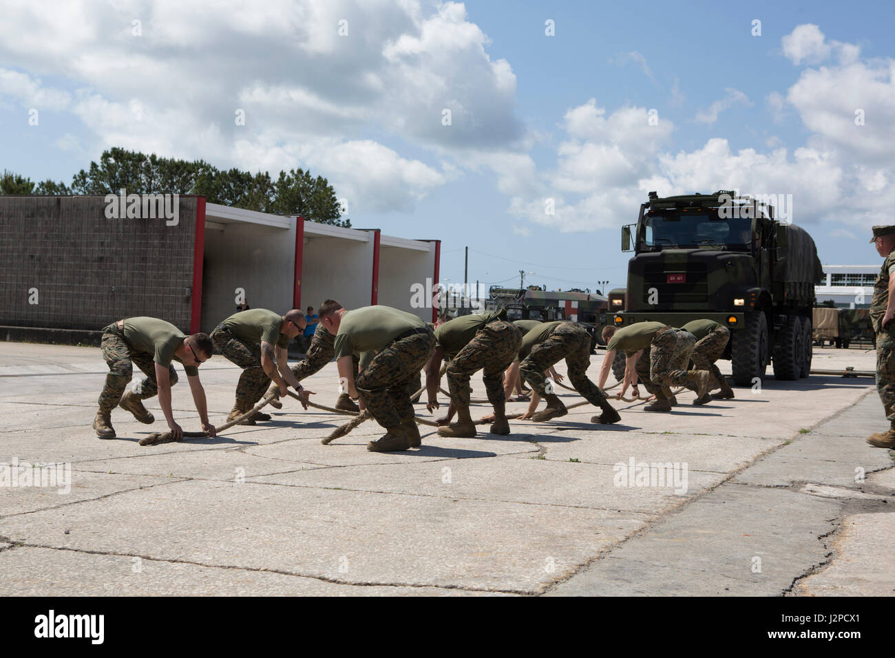 U.S. Marines with Headquarters and Supply Company, 2nd Assault Amphibian Battalion, 2d Marine Division (2d MARDIV), participate in the 7-ton pulling portion of the 2017 Gator games squad competition at Courthouse Bay on Camp Lejeune, N.C., April 20, 2017.Personnel participated in the 2nd Assault Amphibian Battalion squad competition to increase the overall confidence, unit cohesion and moral of junior and senior Marines. (U.S. Marine Corps photo by Lance Cpl. Angel Travis) Stock Photo