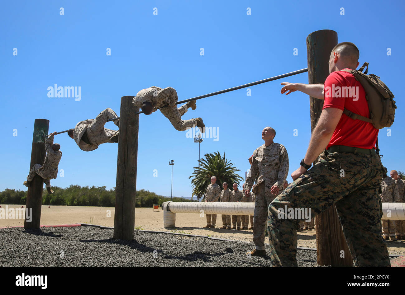 Recruits from Delta Company, 1st Recruit Training Battalion, maneuver over high bars during Obstacle Course II at Marine Corps Recruit Depot San Diego, April 20. If a recruit failed to complete an obstacle the first time, he was sent back to try it again. Annually, more than 17,000 males recruited from the Western Recruiting Region are trained at MCRD San Diego. Delta Company is scheduled to graduate June 30. Stock Photo