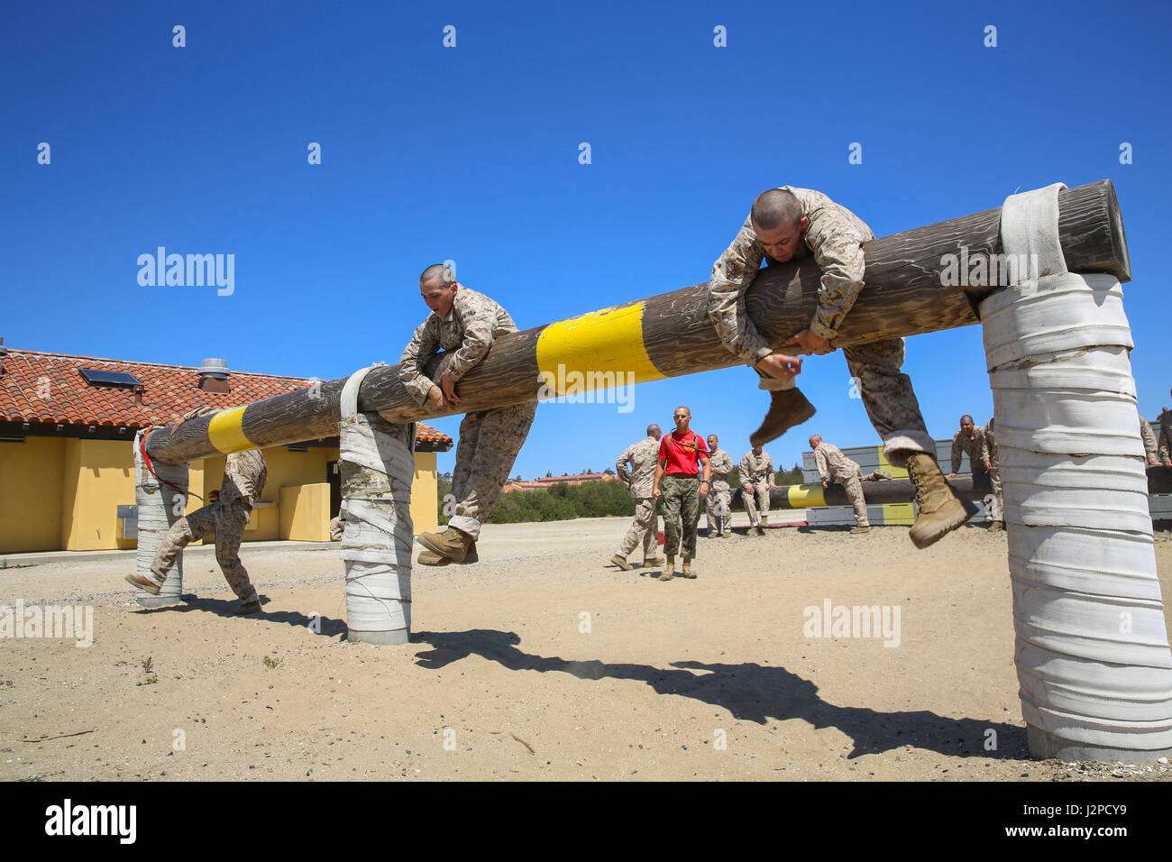 Recruits from Delta Company, 1st Recruit Training Battalion, maneuver over high logs during Obstacle Course II at Marine Corps Recruit Depot San Diego, April 20. If a recruit failed to complete an obstacle the first time, he was sent back to try it again. Annually, more than 17,000 males recruited from the Western Recruiting Region are trained at MCRD San Diego. Delta Company is scheduled to graduate June 30. Stock Photo