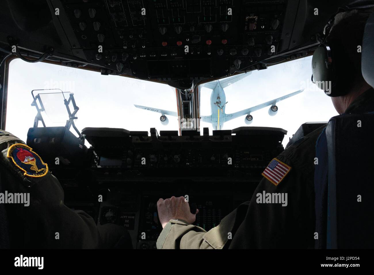 Lt. Col. Richard Carter, right, a pilot for the 105th Airlift Wing, maneuvers a C-17 Globemaster III aircraft during in-flight refueling of a C-17 Globemaster III based at the 105th Airlift Wing, Stewart Air National Guard Base, New York April 20, 2017. The training included included low-level, touch-and-go and aerial refueling practice. (U.S. Air Force photo by Master Sgt. Sara A. Pastorello) Stock Photo
