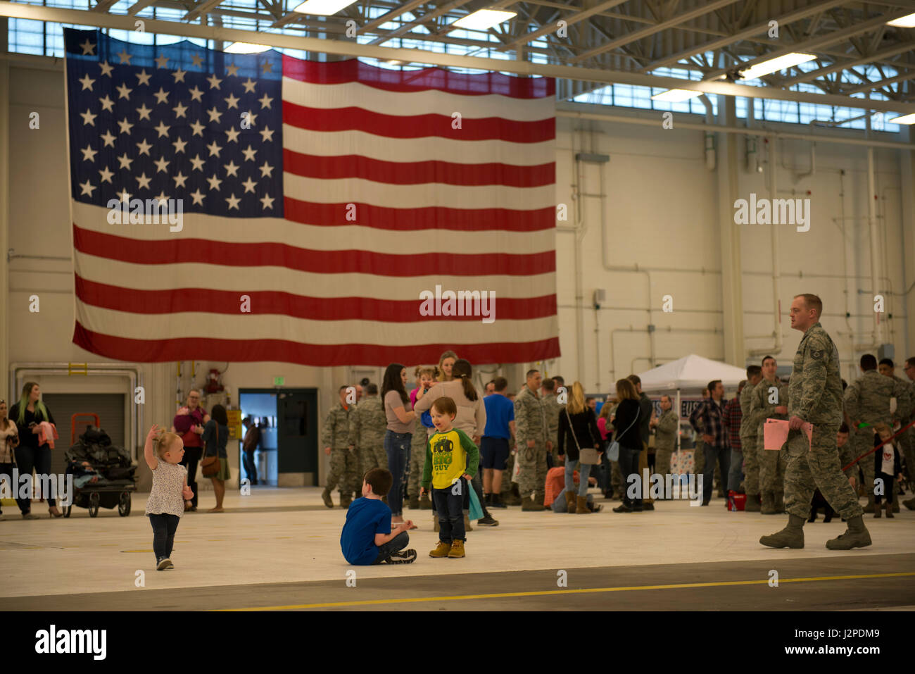 Friends and Families wait at Hangar 25 on Joint Base Elmendorf-Richardson, Alaska April 21 for the 525th Fighter Squadron to return from a 7-month deployment. For many families, this was their first time being separated from their loved ones for an extended period of time. (U.S. Air Force photo by Senior Airman Kyle Johnson) Stock Photo