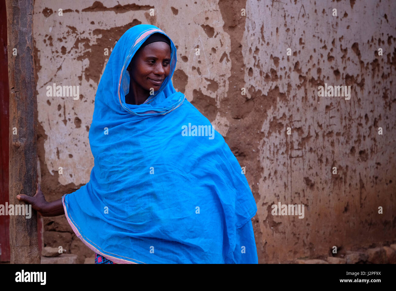 A woman wearing a traditional Khanga garment in Mwamgongo village located on the shore of Tanganyika lake in west-central Tanzania Eastern Africa Stock Photo
