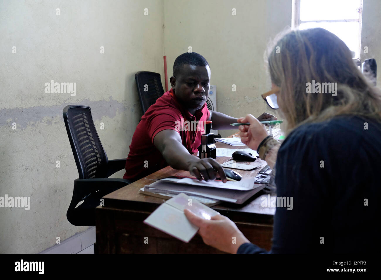 A tourist fills a document at the passport control room in the departure hall of terminal 1 of Julius nyerere airport in Dar es Salaam, the largest city of Tanzania in eastern Africa Stock Photo