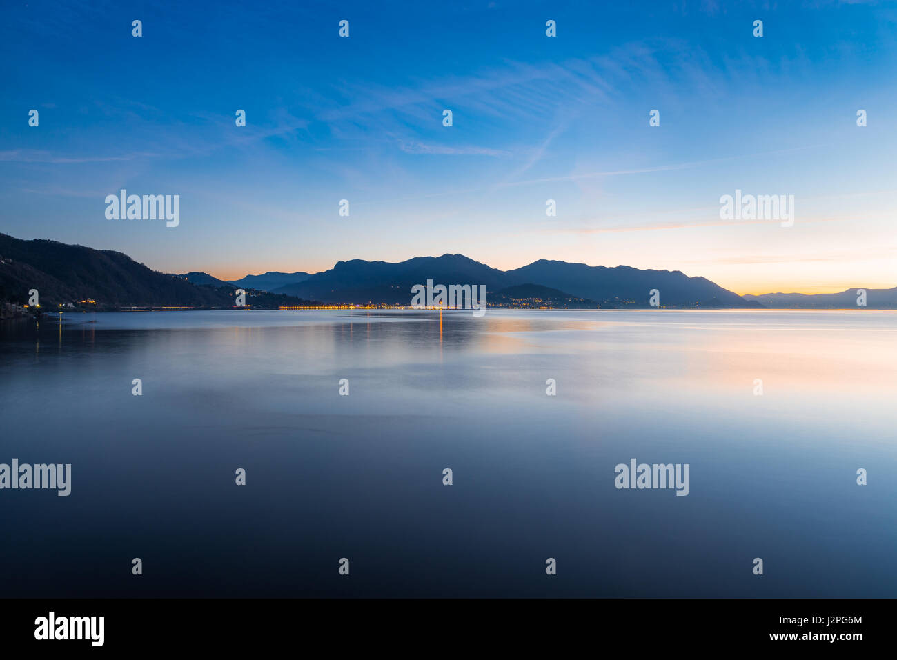 Lake Maggiore, Maccagno, Italy. Panorama towards Luino, during a quiet and beautiful sunset Stock Photo