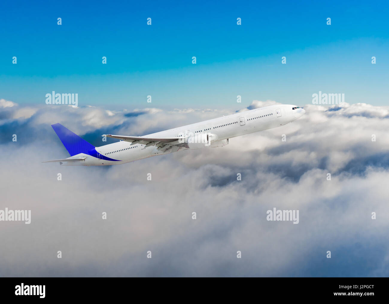 Passenger airplane flying above dramatic clouds Stock Photo - Alamy