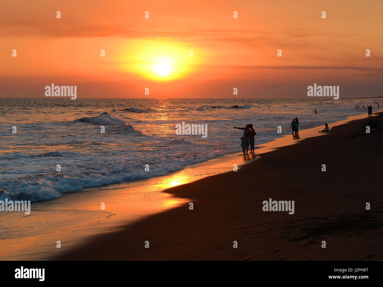 Memory of a sunset with a view over the Pacific Ocean by the volcanic sand beach of Monterrico, Guatemala. Stock Photo