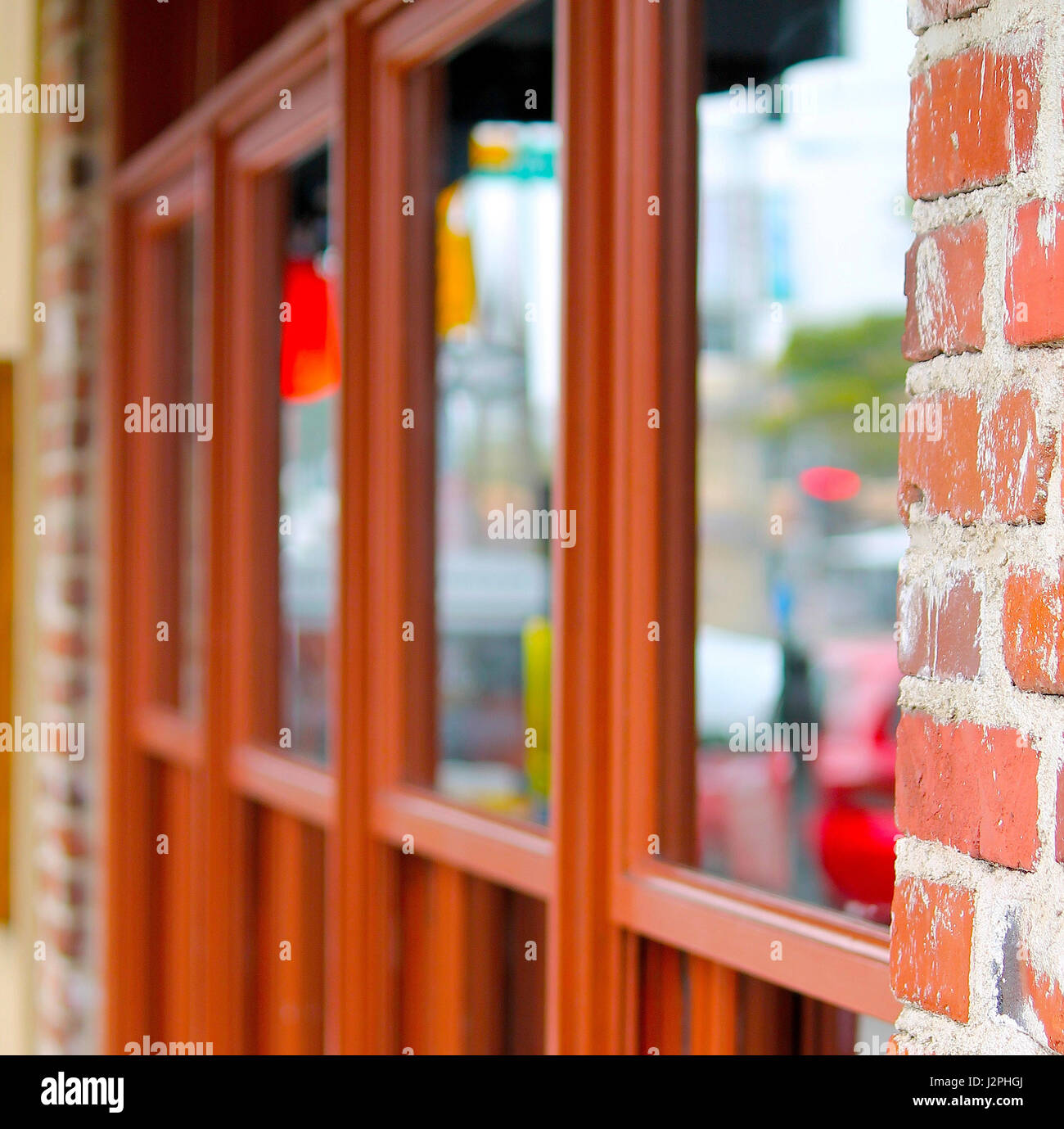 Red Windows of Cafe on city sidewalk Stock Photo