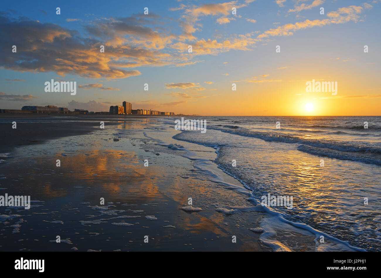 Sunset by the North Sea beach of Oostende (Ostend in English) and its skyline, Belgium. Stock Photo