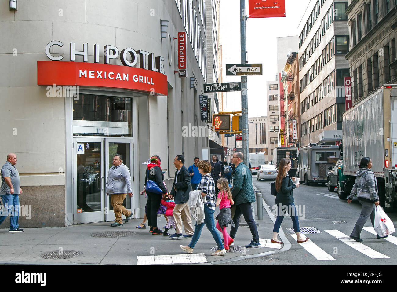 People walk by a Chipotle Mexican Grill restaurant in downtown Manhattan. Stock Photo