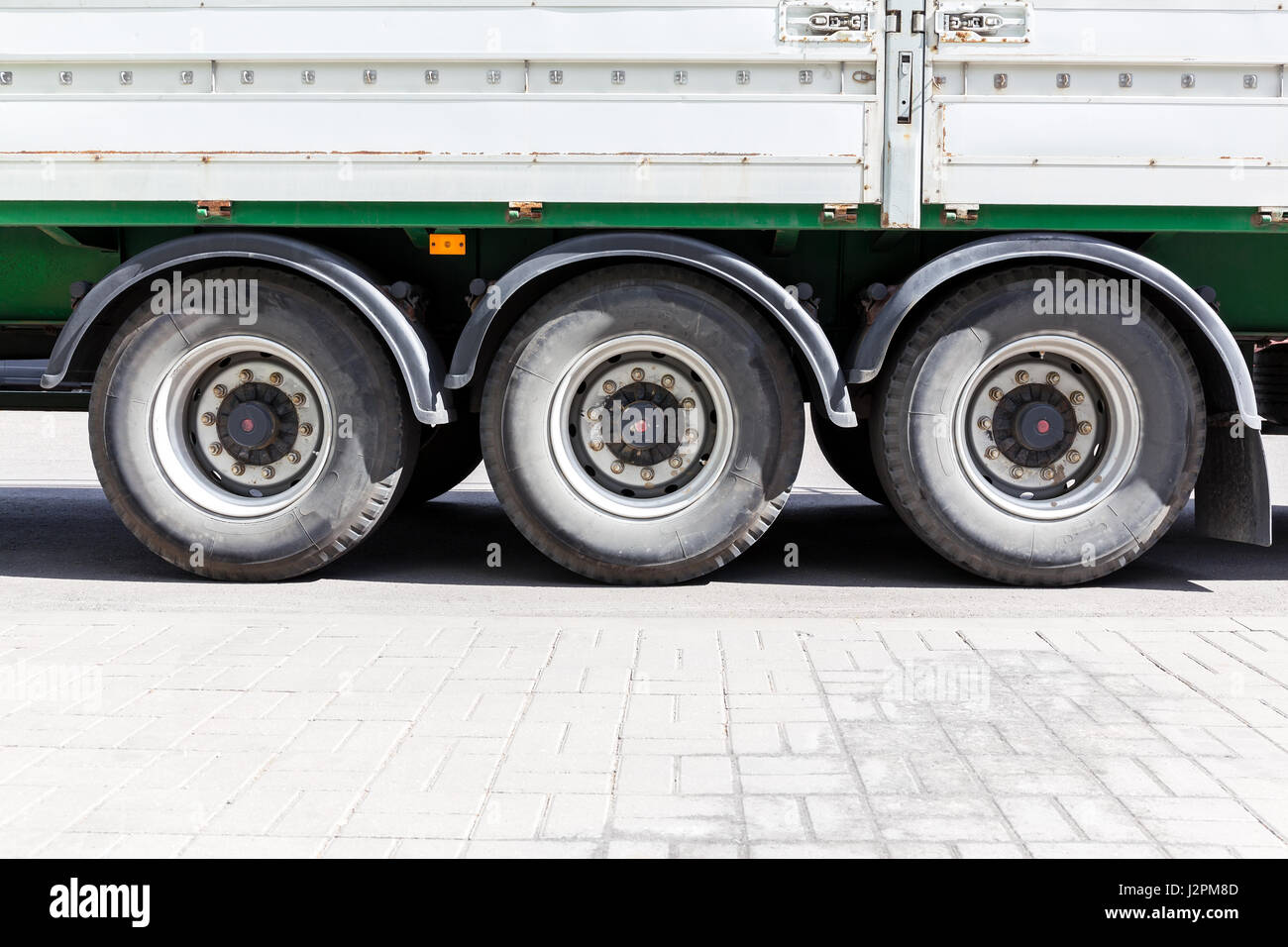 wheels of large truck and trailers at parking lot closeup view Stock Photo