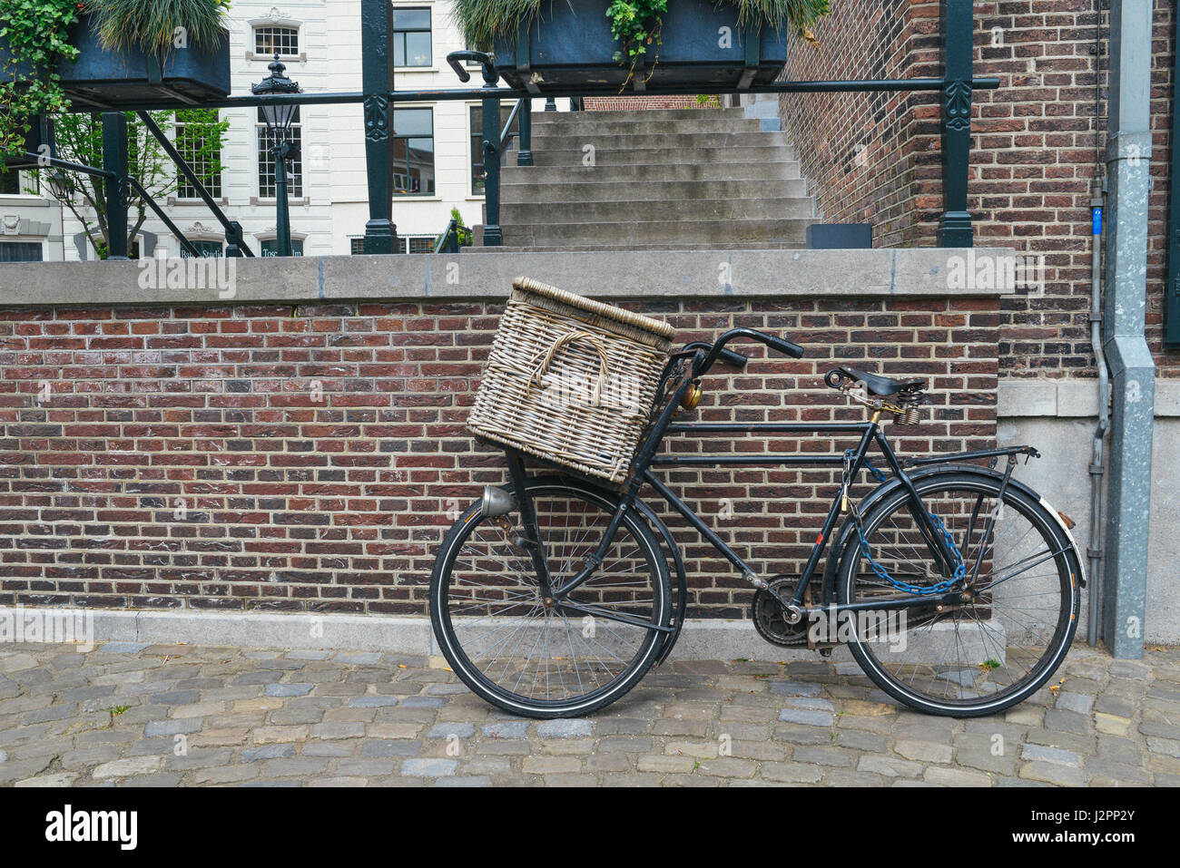 Traditional retro Dutch bike with basket against a wall Stock Photo Alamy
