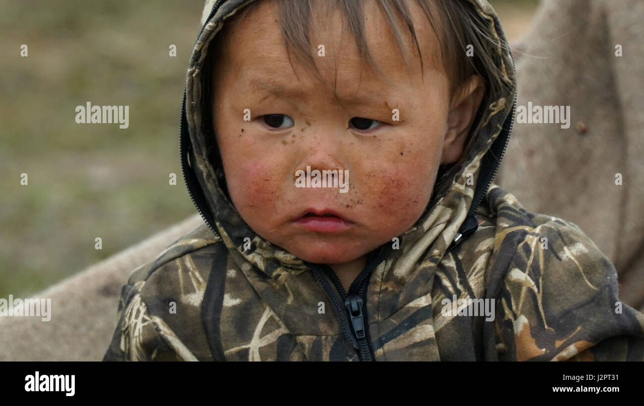 Nenets child in a nomadic camp in the tundra on the Yamal Peninsula. Summer. Stock Photo