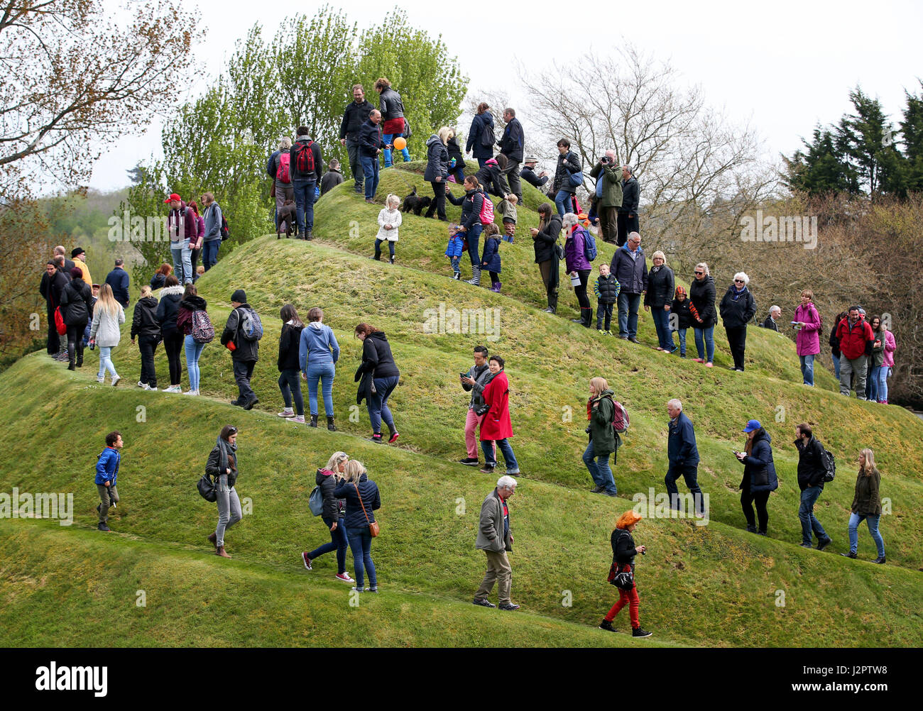 Visitors climb the Snail Mound in the Garden of Cosmic Speculation in the grounds of Portrack House near Dumfries. Stock Photo