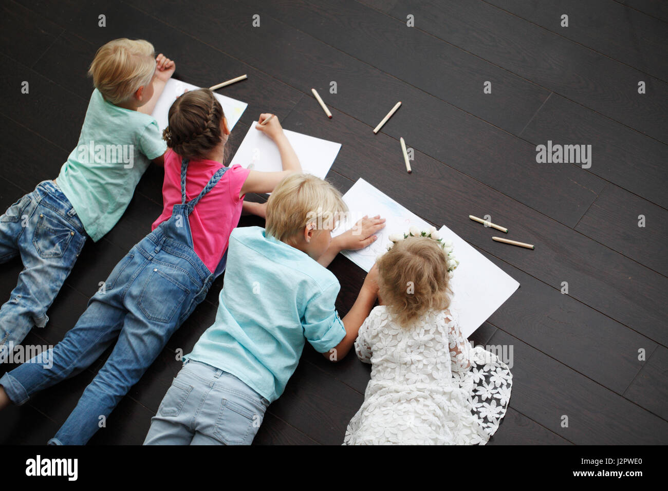 Group of cute children drawing with colorful pencils on floor Stock ...