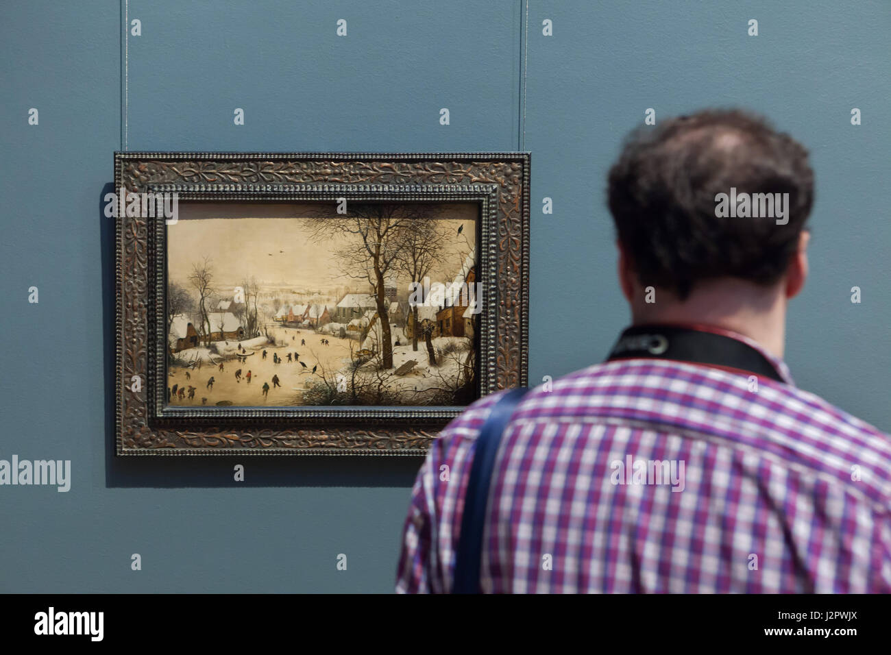 Visitor In Front Of The Painting Winter Landscape With Skaters And A Bird Trap By Dutch Renaissance Painter Pieter Bruegel The Elder 1565 Displayed In The Royal Museums Of Fine Arts In Visitor In Front Of The Painting Winter Landscape With Skaters And A Bird Trap By Dutch Renaissance Painter Pieter Bruegel The Elder 1565 Displayed In The Royal Museums Of Fine Arts In