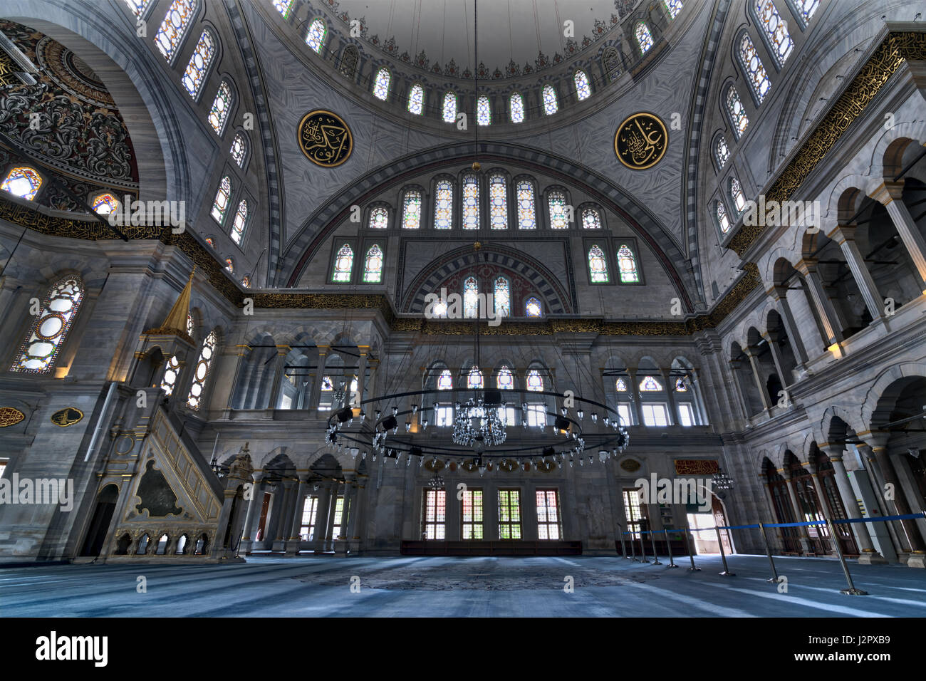Interior of Nuruosmaniye Mosque, an Ottoman Baroque style mosque completed in 1755, with a huge dome & many colored stained glass windows located in S Stock Photo