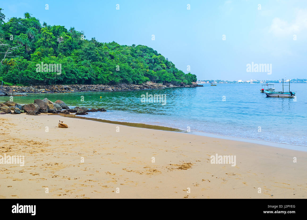 The cozy sand Jungle Beach is the nice place to relax after visiting of Temples on Rumassala Mount, Unawatuna, Sri Lanka. Stock Photo