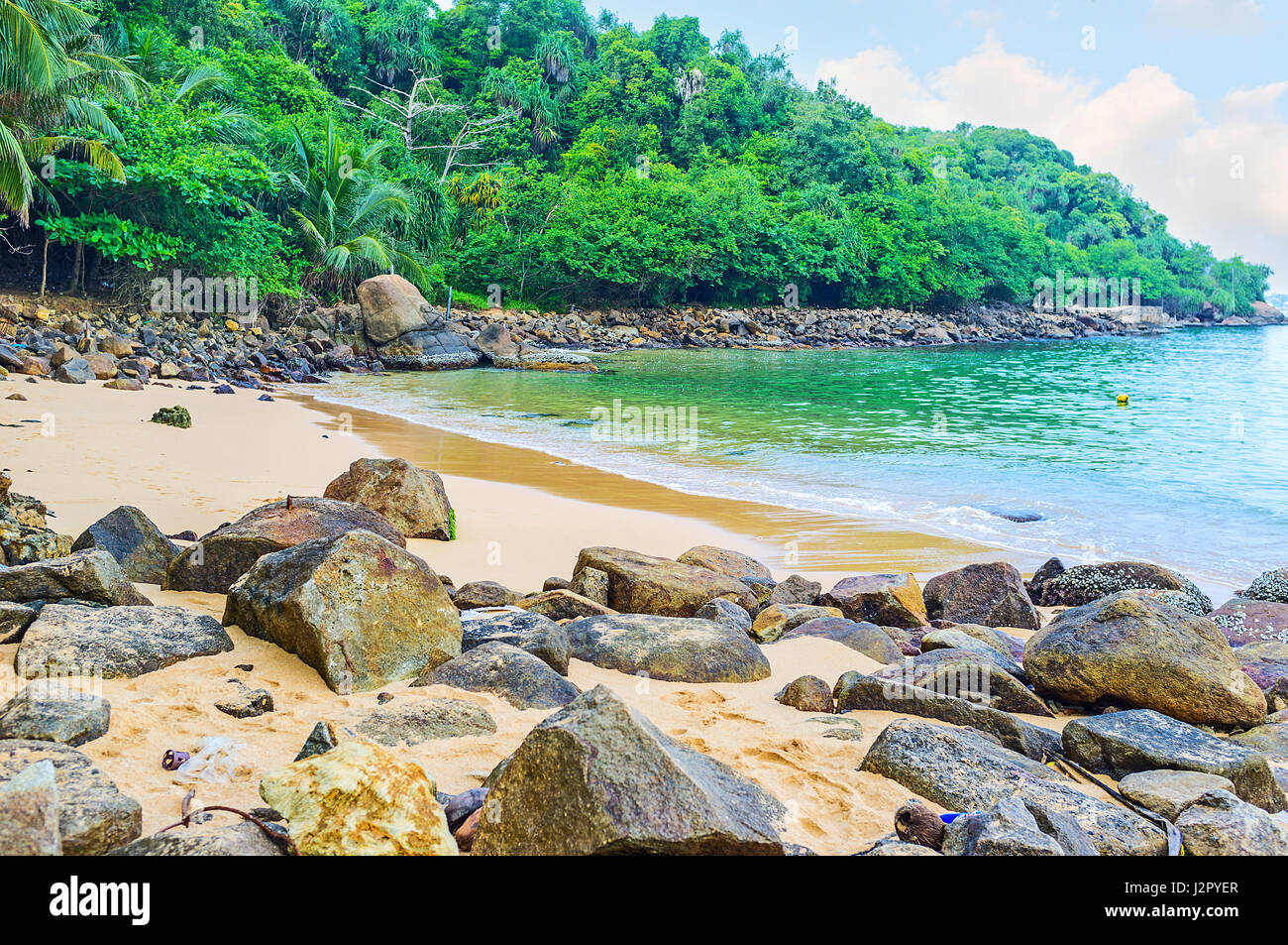 The boulders on the shore of Jungle Beach in Unawatuna, Sri Lanka. Stock Photo