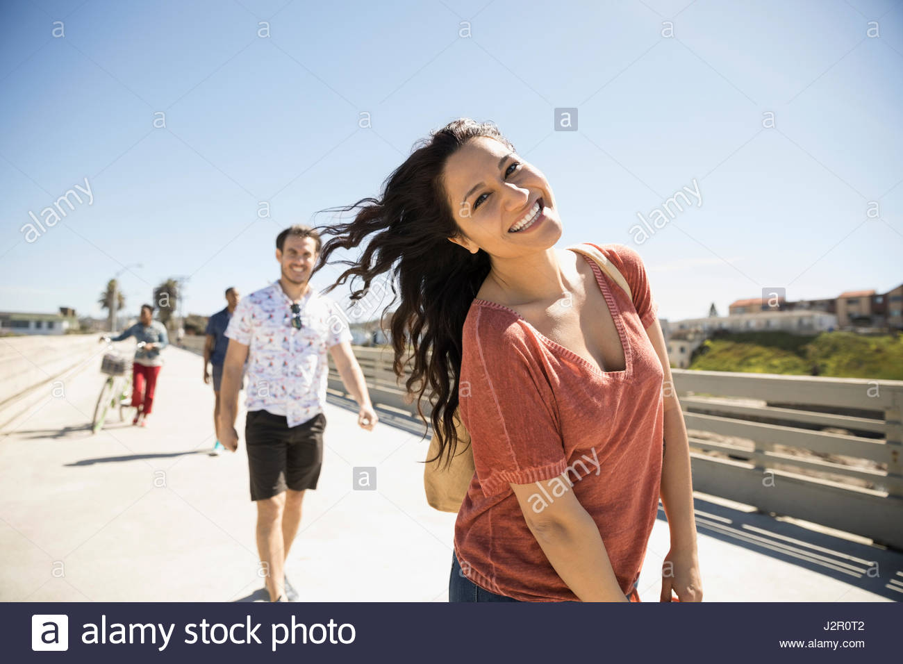 Portrait smiling, playful woman on sunny bridge Stock Photo - Alamy