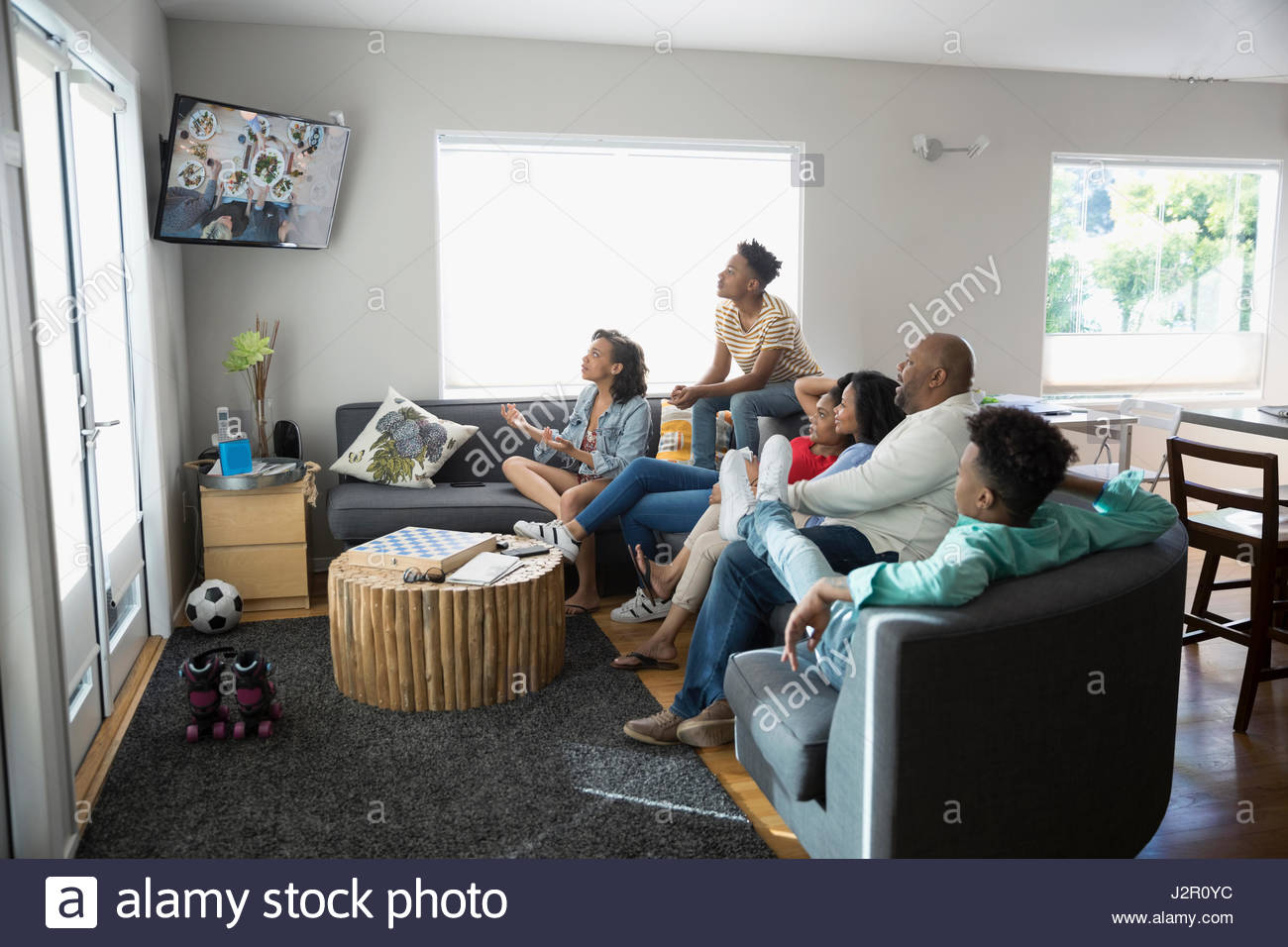 African American family watching TV in living room Stock Photo
