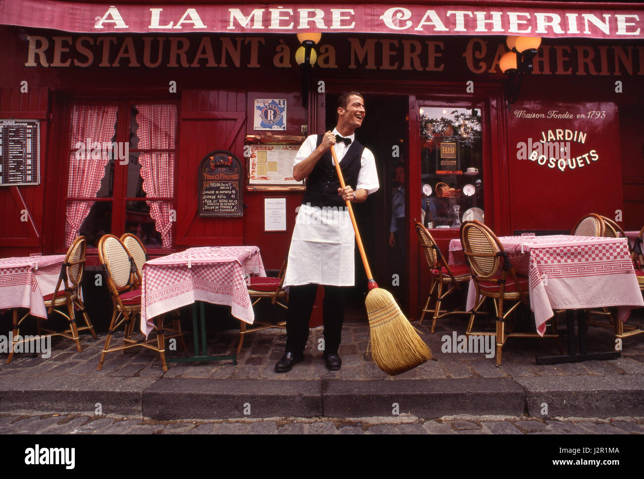 PARIS FRENCH WAITER MONTMARTRE Classic waiter, morning   preparations at landmark Parisian restaurant 'A La Mere Catherine', Montmartre, Paris France. Stock Photo