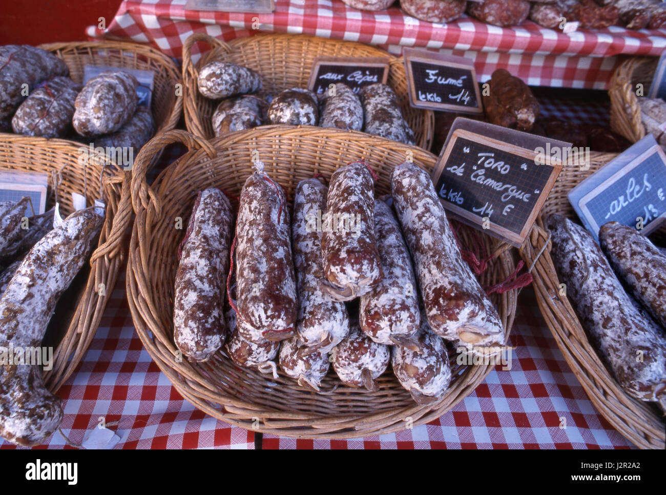 SAUCISSE French sausage display variety rustic Saucission on market stall euro price boards traditional Beaune town market, Beaune, Côte d'Or, France. Stock Photo