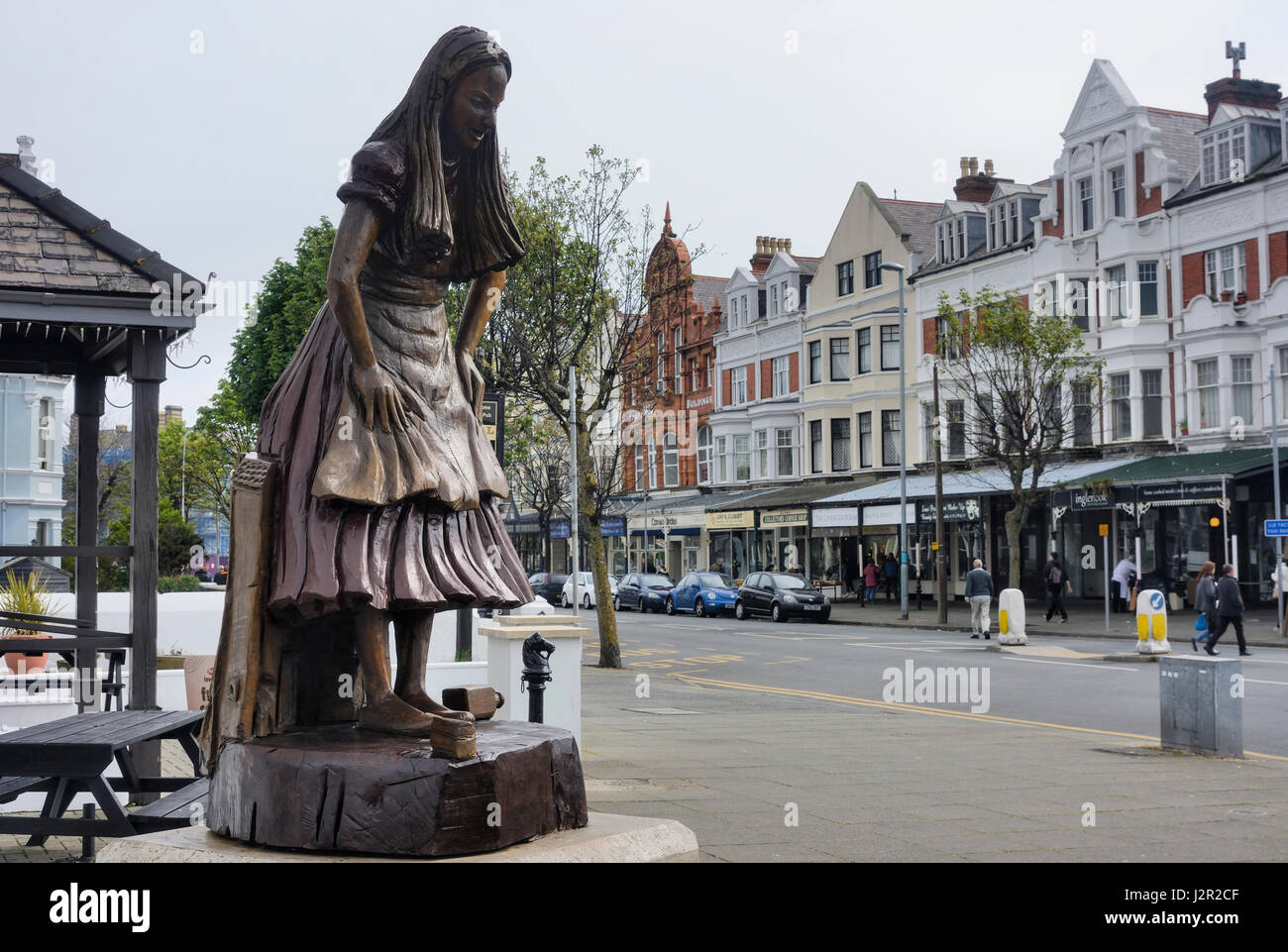 Alice in Wonderland carved wooden statue in Llandudno Stock Photo Alamy