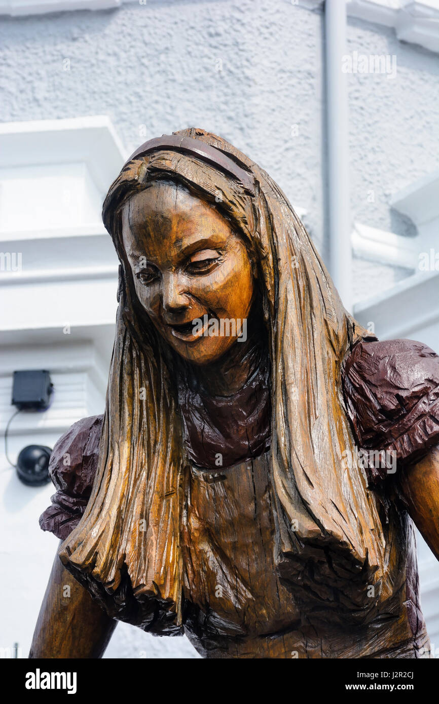 Alice in Wonderland carved wooden statue in Llandudno Stock Photo Alamy