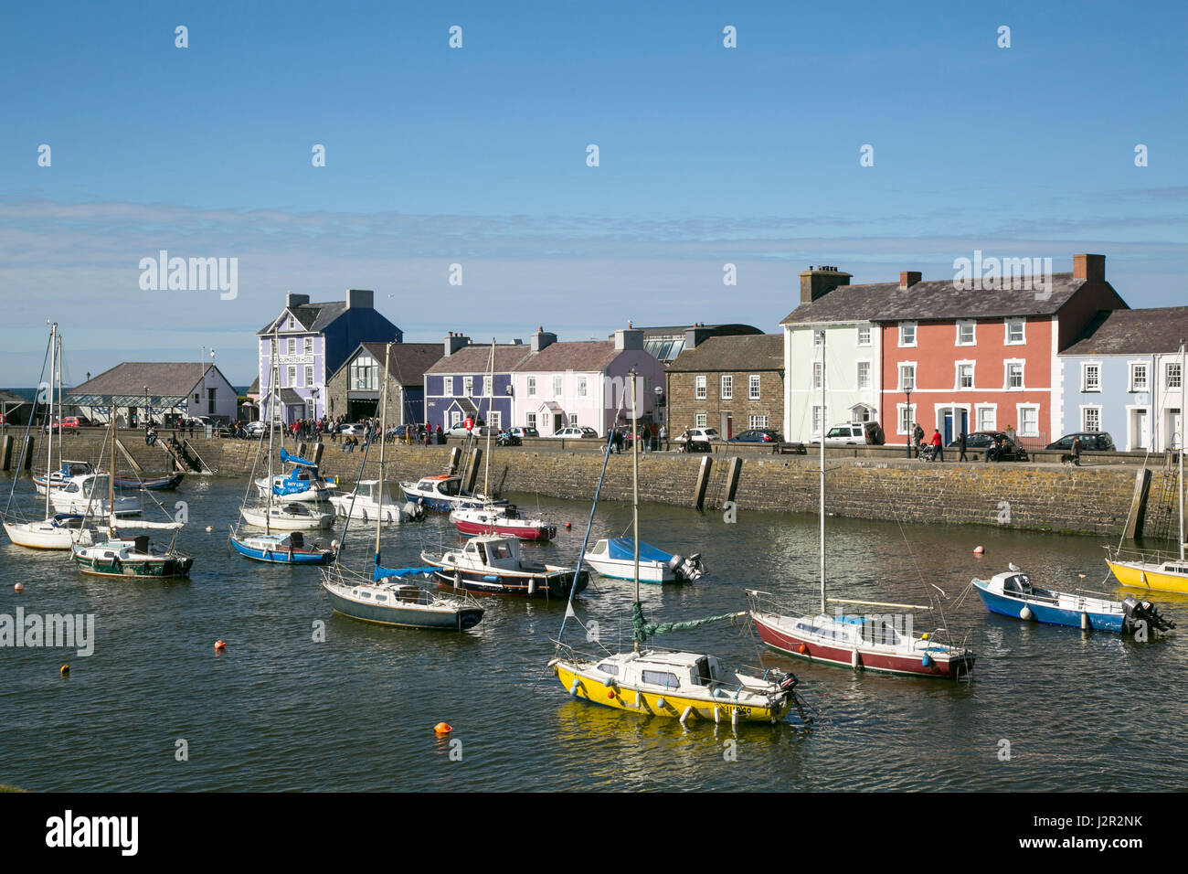 The charming Georgian port town of Aberaeron on the Cardigan Bay Coast, Ceredigion, West Wales with sailing boats and fishing boats in the harbour. Stock Photo