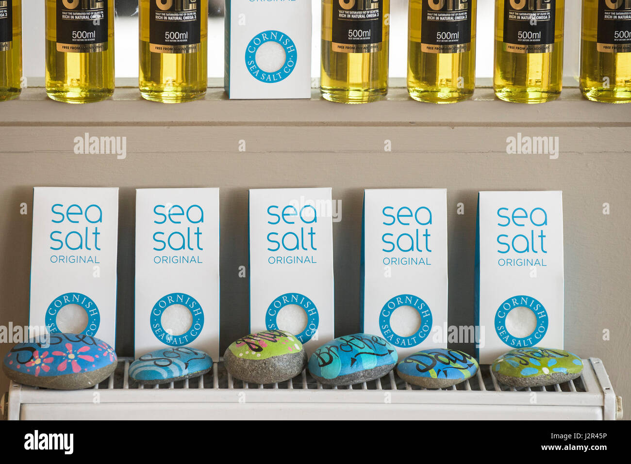 Packets of Cornish Sea salt Display On sale Decorated pebbles Painted pebbles Stock Photo