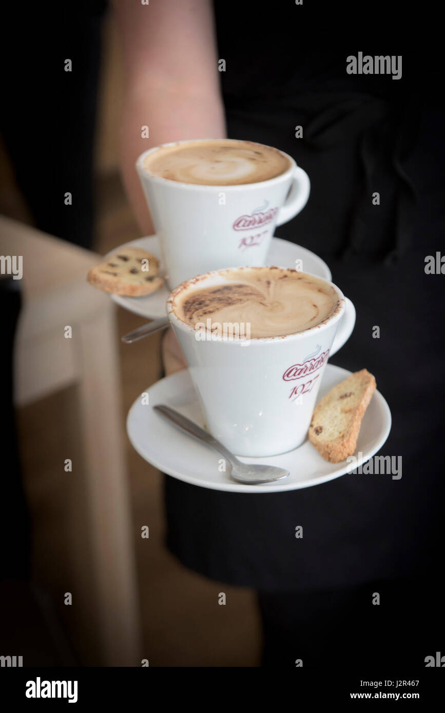 Restaurant interior Waitress service Two cappuccinos Coffee drink Coffee break Coffee time Being served Stock Photo