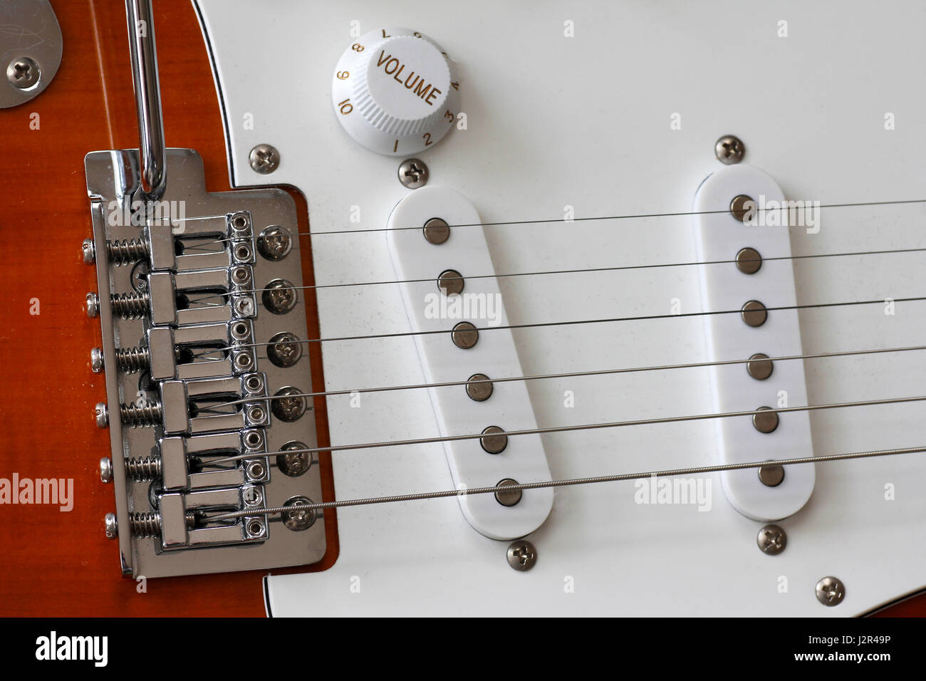 Macro of electric guitar strings and single pickup and pickguards Stock Photo