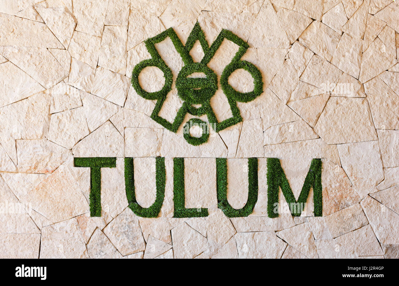 Tulum sign of grass letters on the stone wall in Tulum Mexico Stock Photo