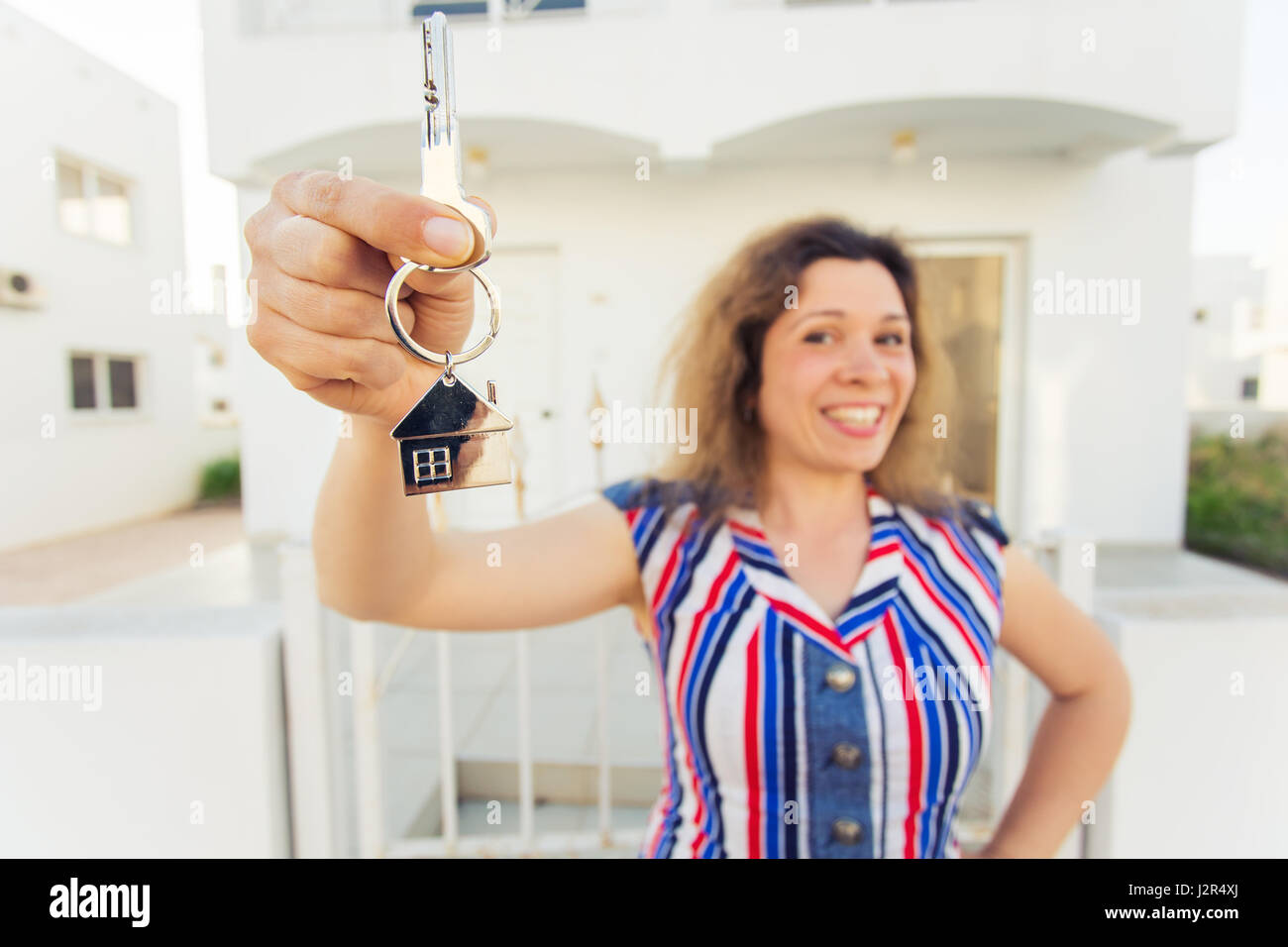 Young woman In Front of New Home with New House Keys Stock Photo - Alamy