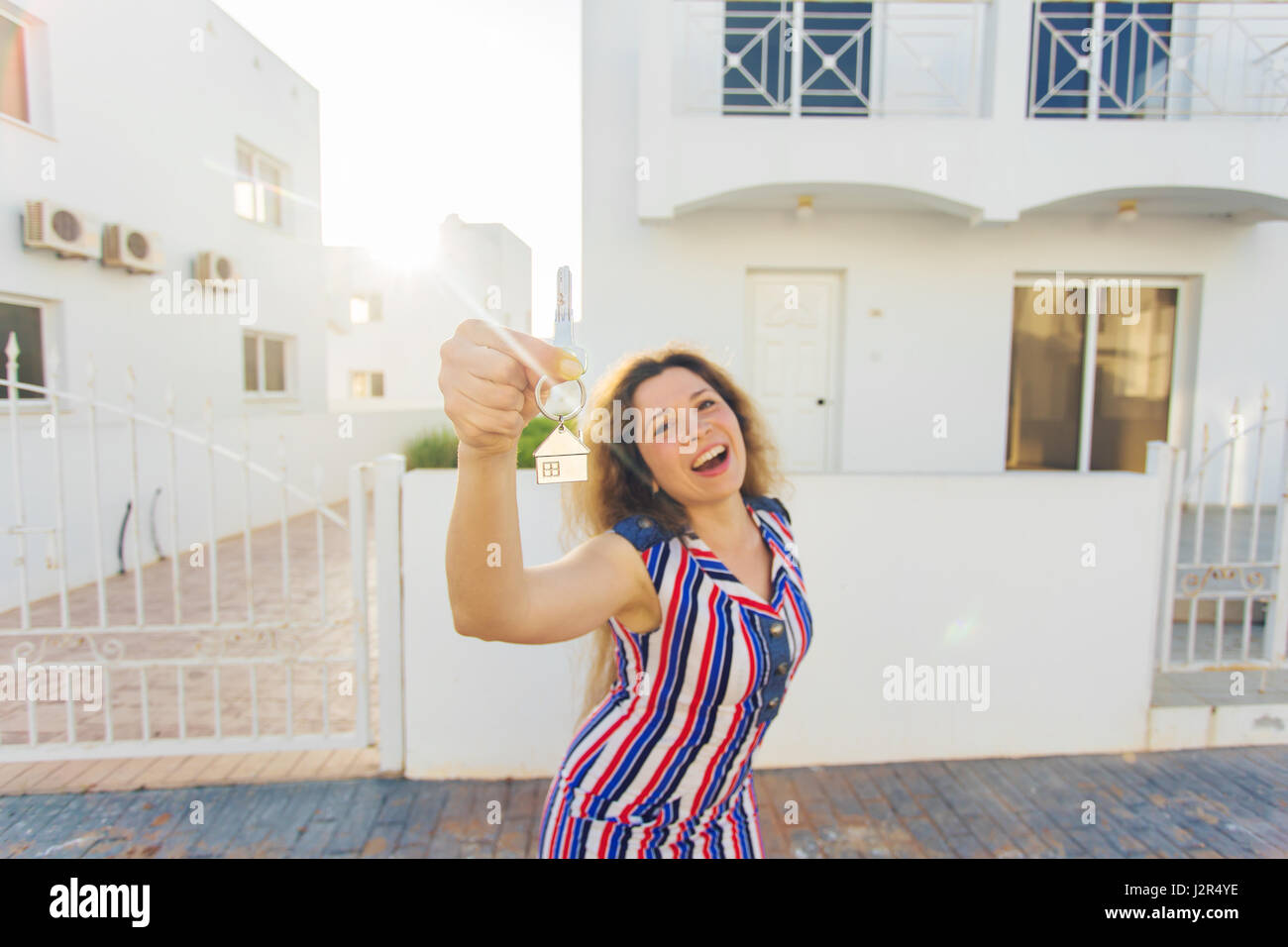 Young woman In Front of New Home with New House Keys Stock Photo - Alamy