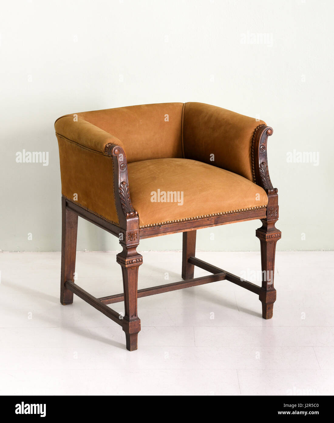 Antique wooden armchair with soft upholstery in white room Stock Photo ...