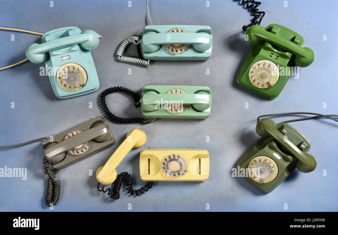 Collection of old vintage rotary telephones in blue, green, yellow and grey viewed from above in a retro collectibles or communication concept Stock Photo