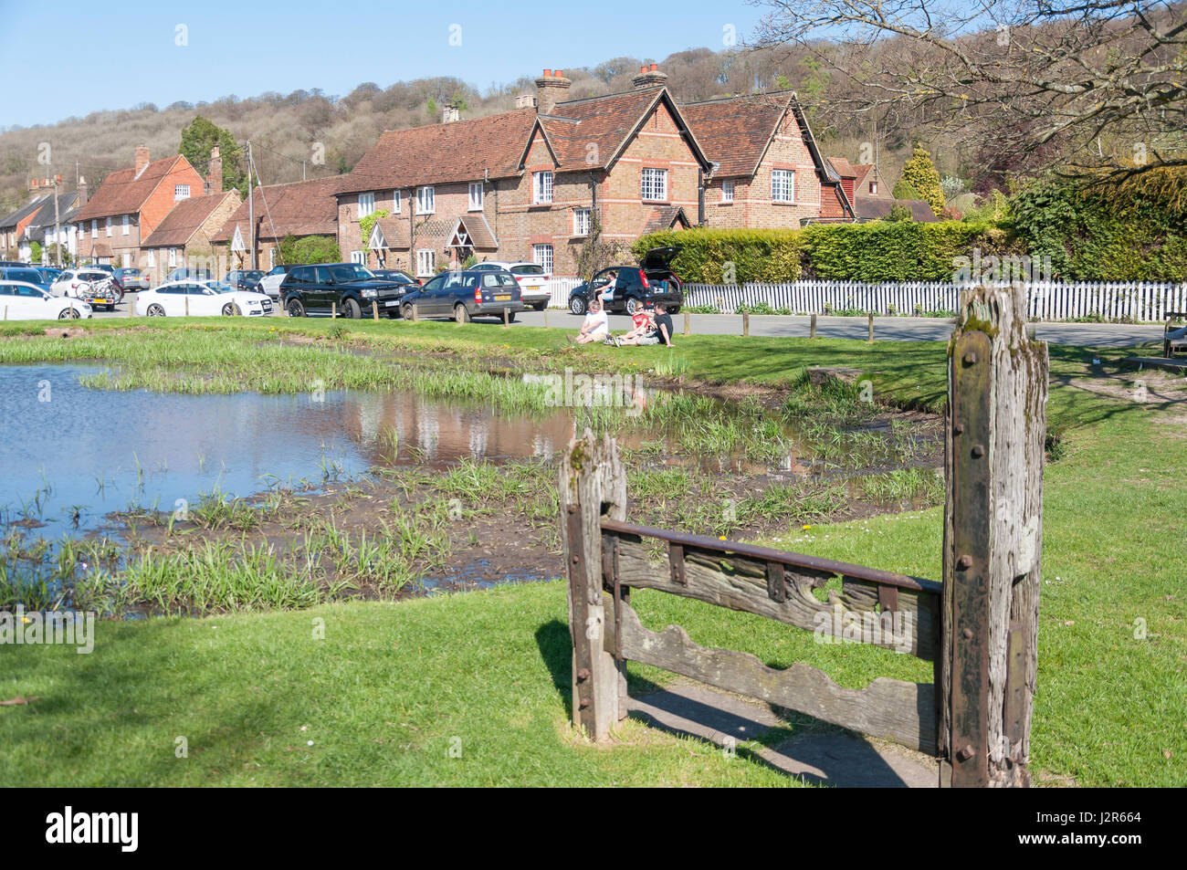 Ancient stocks by village pond, Aldbury, Hertfordshire, England, United Kingdom Stock Photo