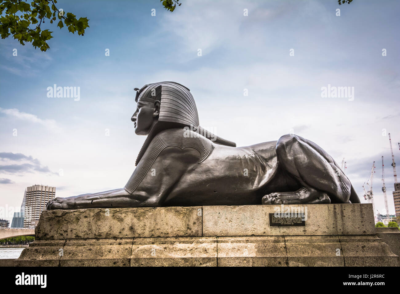 A bronze Sphinx next to Cleopatra's Needle, Victoria Embankment, London, England, UK Stock Photo