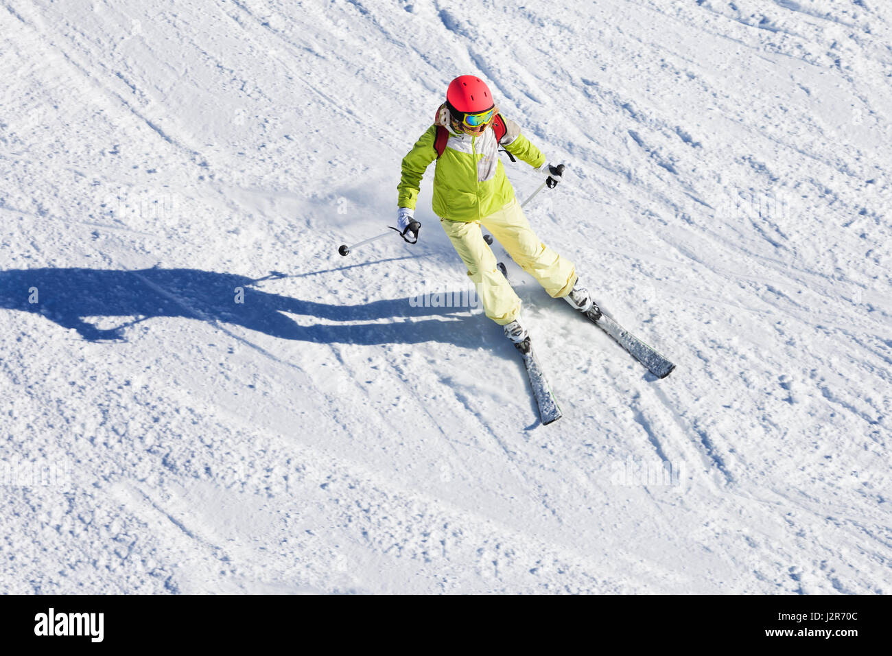 Top view portrait of female skier hitting the slopes at sunny day Stock Photo