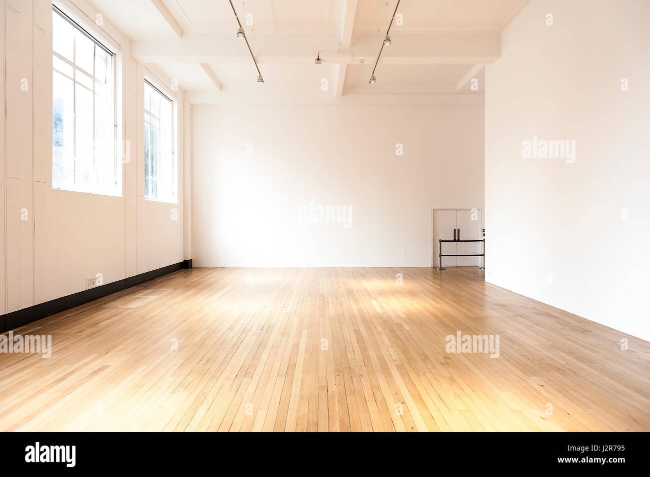 Empty room with white walls and wooden parquet floor Stock Photo